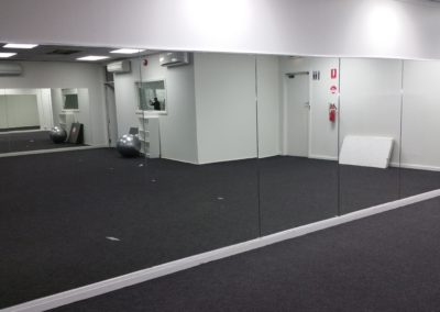 Gym mirrors installed using a chrome J channel